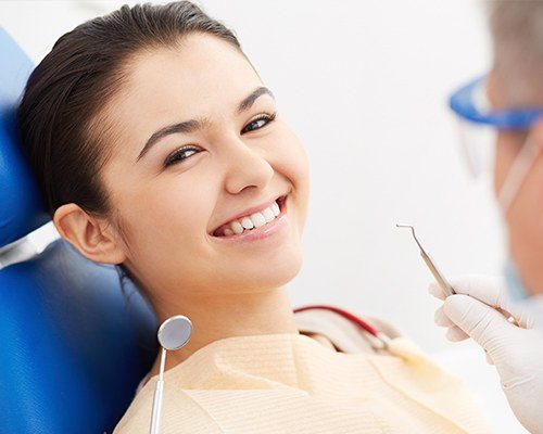 Woman in dental chair smiling