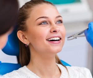 A dentist pulling a patient’s tooth