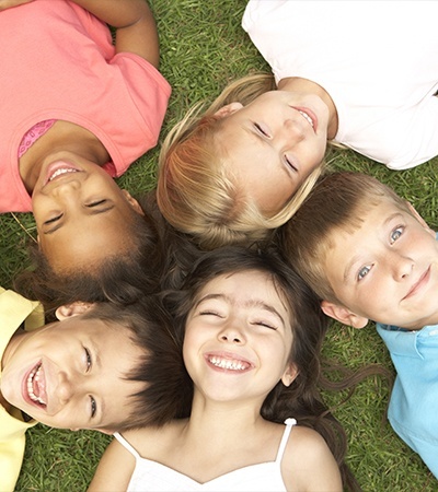 Group of kids laughing together outdoors