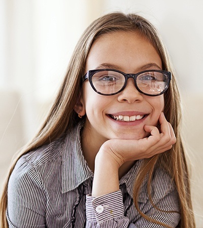 Smiling young girl with glasses
