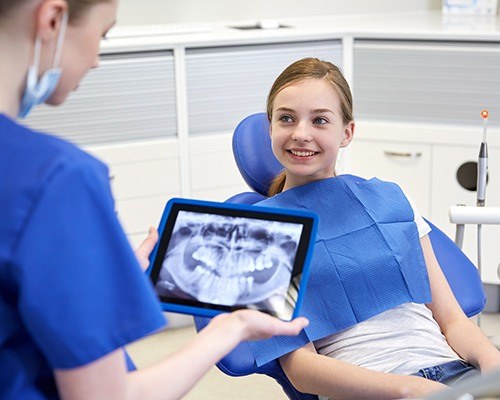 Smiling girl in dental chair