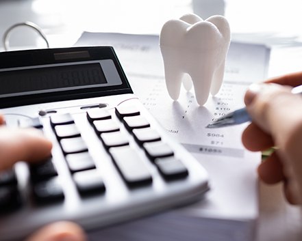 A patient calculating the cost of their dental care