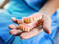 Dentures patient in Center smiling