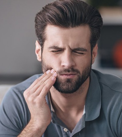 Pained man who should visit his Center emergency dentist