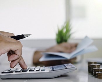 Man calculating cost of tooth extractions in Center