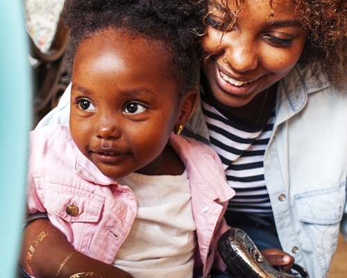 a parent and child smiling