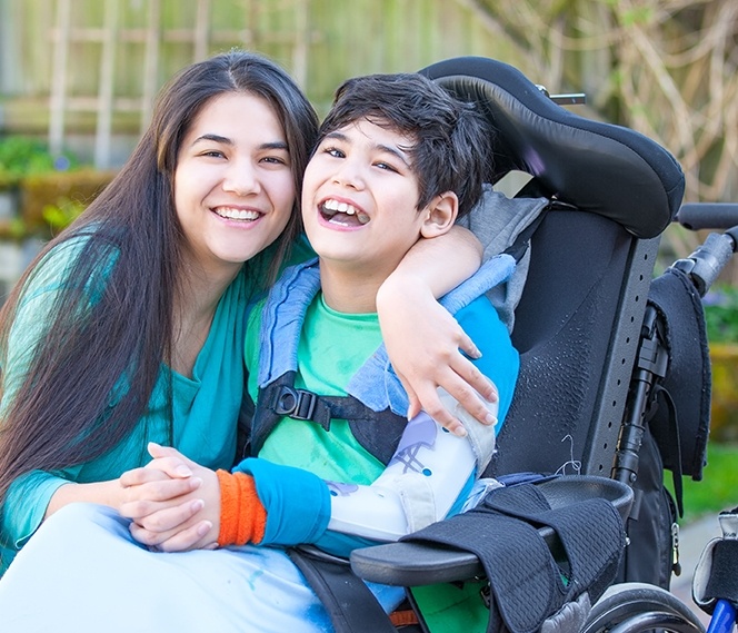 Mother hugging her son who is in a wheelchair