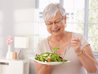 a woman enjoying a healthy salad plate