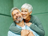 a mature couple smiling and laughing together