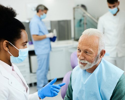 happy man talking to dentist 