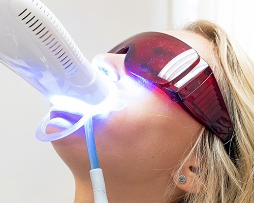 Woman receiving in-office teeth whitening