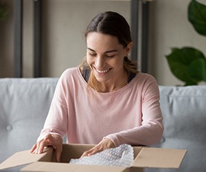 Woman opening a package and smiling