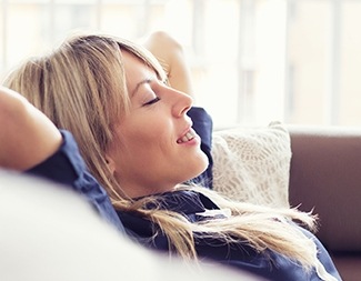 Relaxed woman with hands behind head