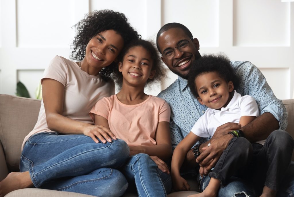 Family smiling on couch