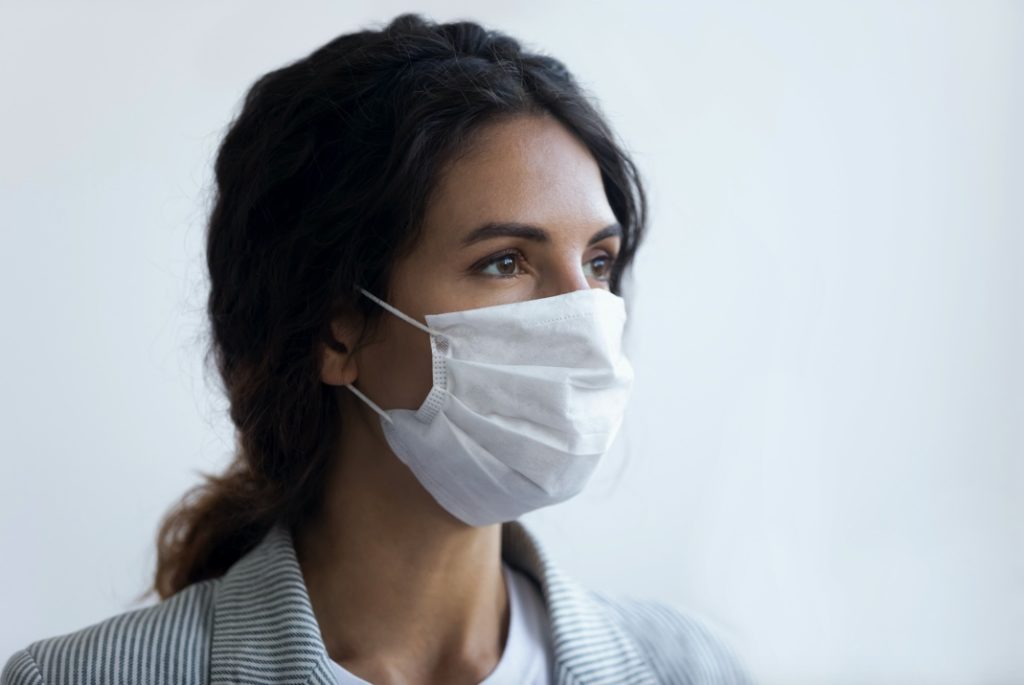 Woman wearing face mask at dentist in Center