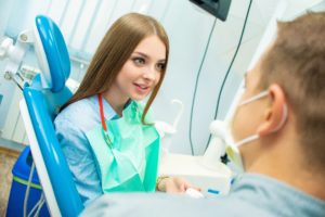 Woman in dental chair at dentist in Center.