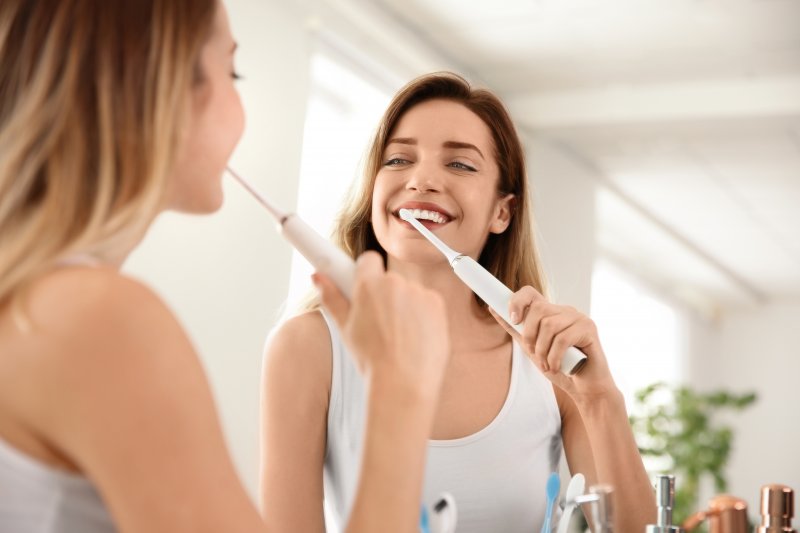 Woman brushing teeth before breakfast