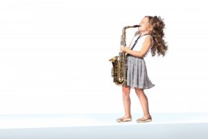 little girl playing a saxophone 