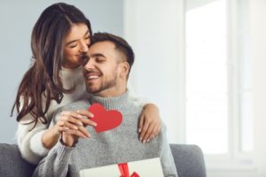 happy couple exchanging Valentine’s Day gifts 