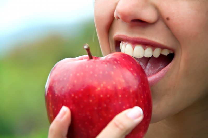Person biting into an apple
