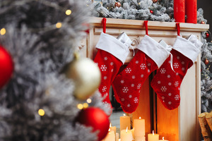 Stockings hanging over some candles in a festive room