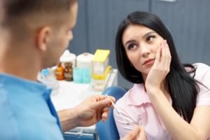 a woman speaking to her dentist after root canal therapy