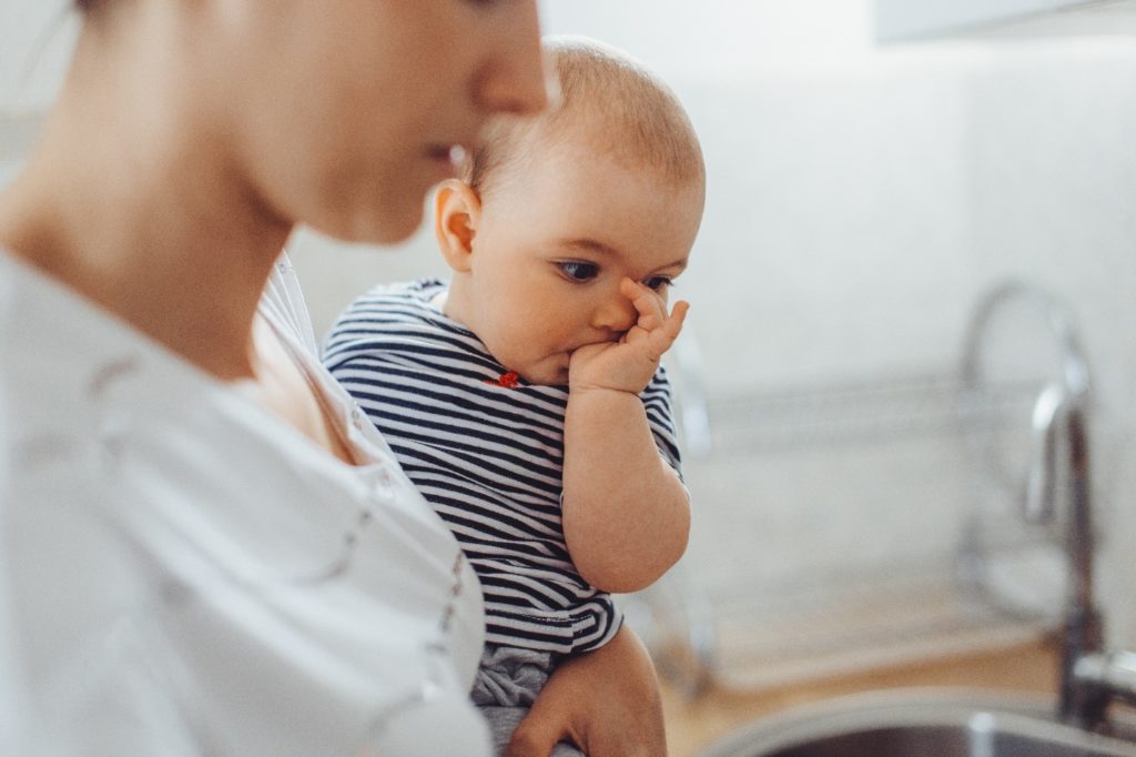 A baby sucking their thumb 