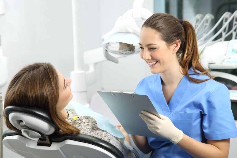 patient speaking with dentist about dental crown lifespan