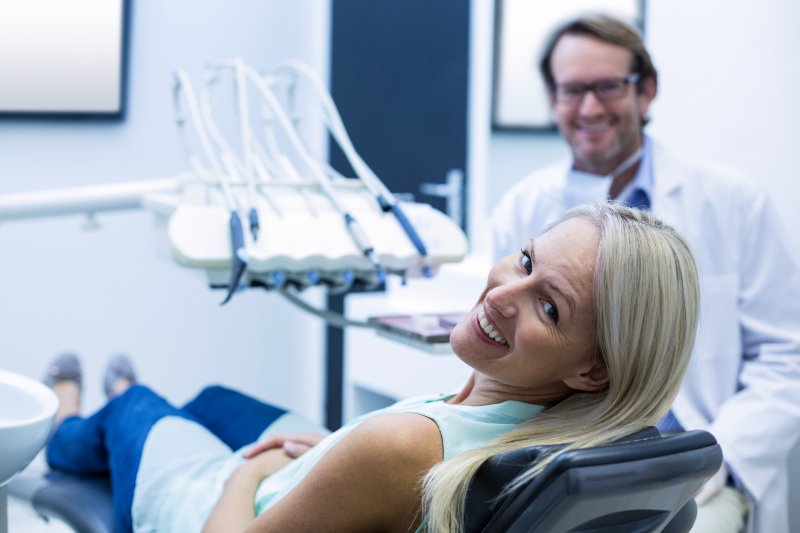 patient smiling while visiting dentist 