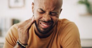 Swollen gums causing man pain.