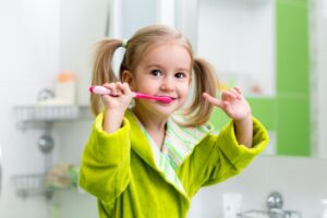 Child brushing teeth.