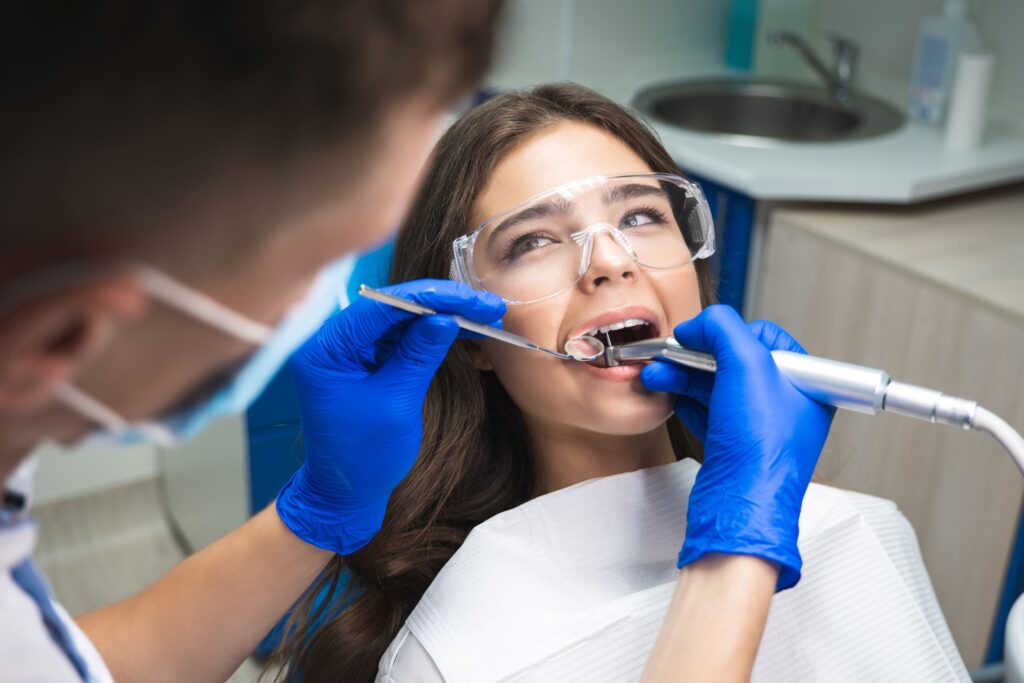 Woman looking at dentist during root canal