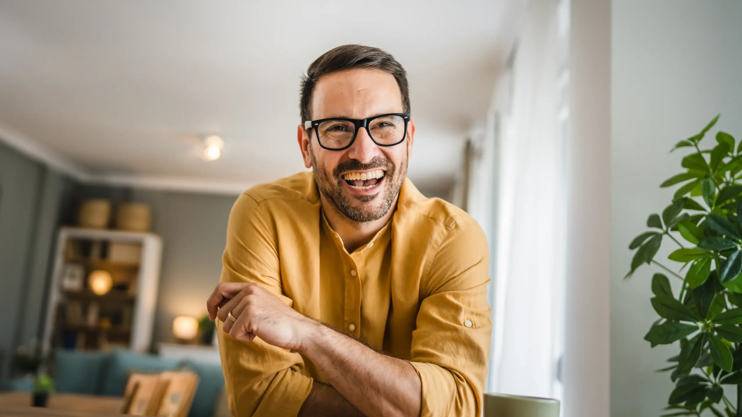 Man smiling indoors showing results of dental checkup and cleaning in Center TX