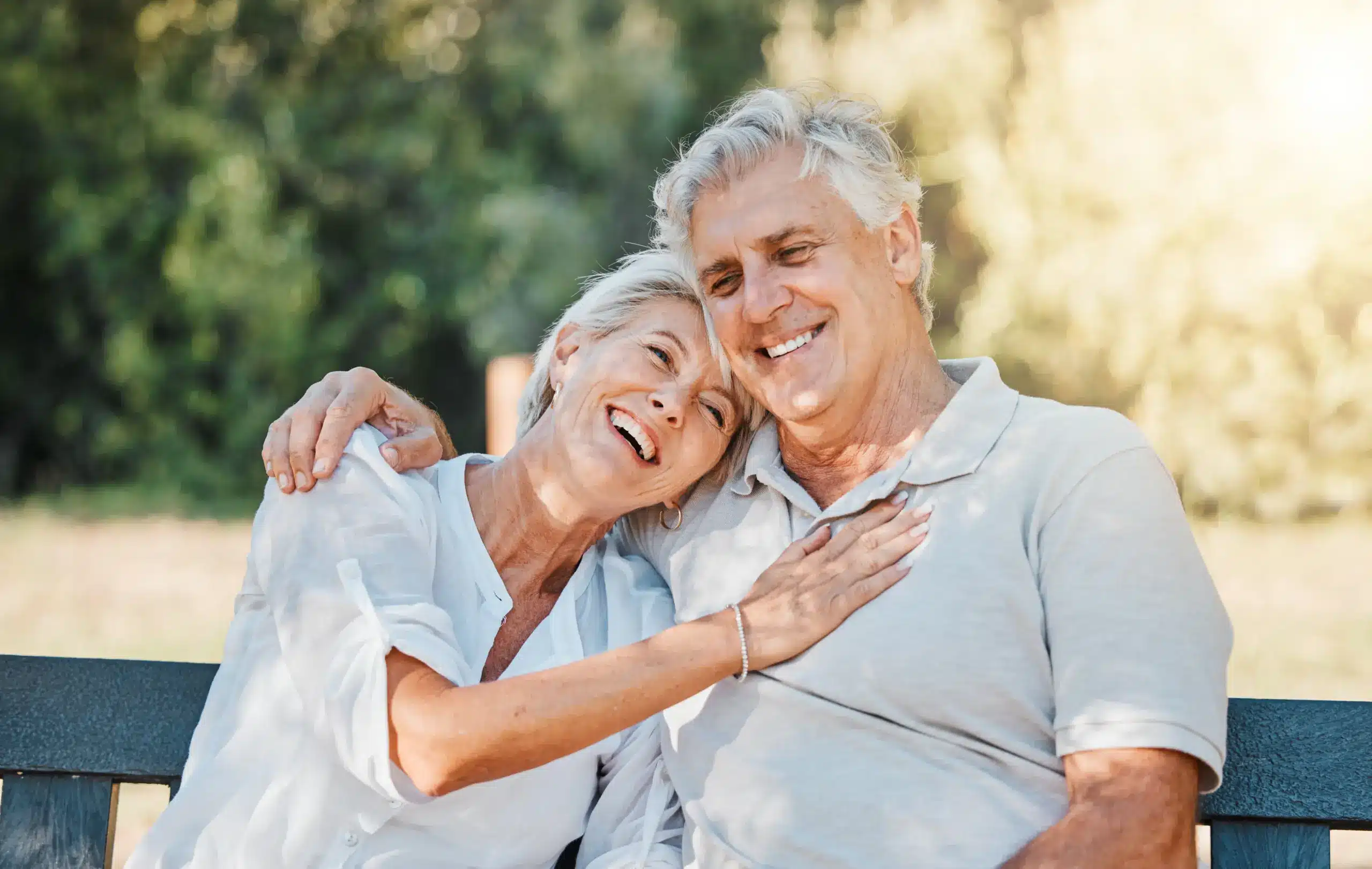 Senior couple smiling together with healthy smiles after Dental Implants in Center TX