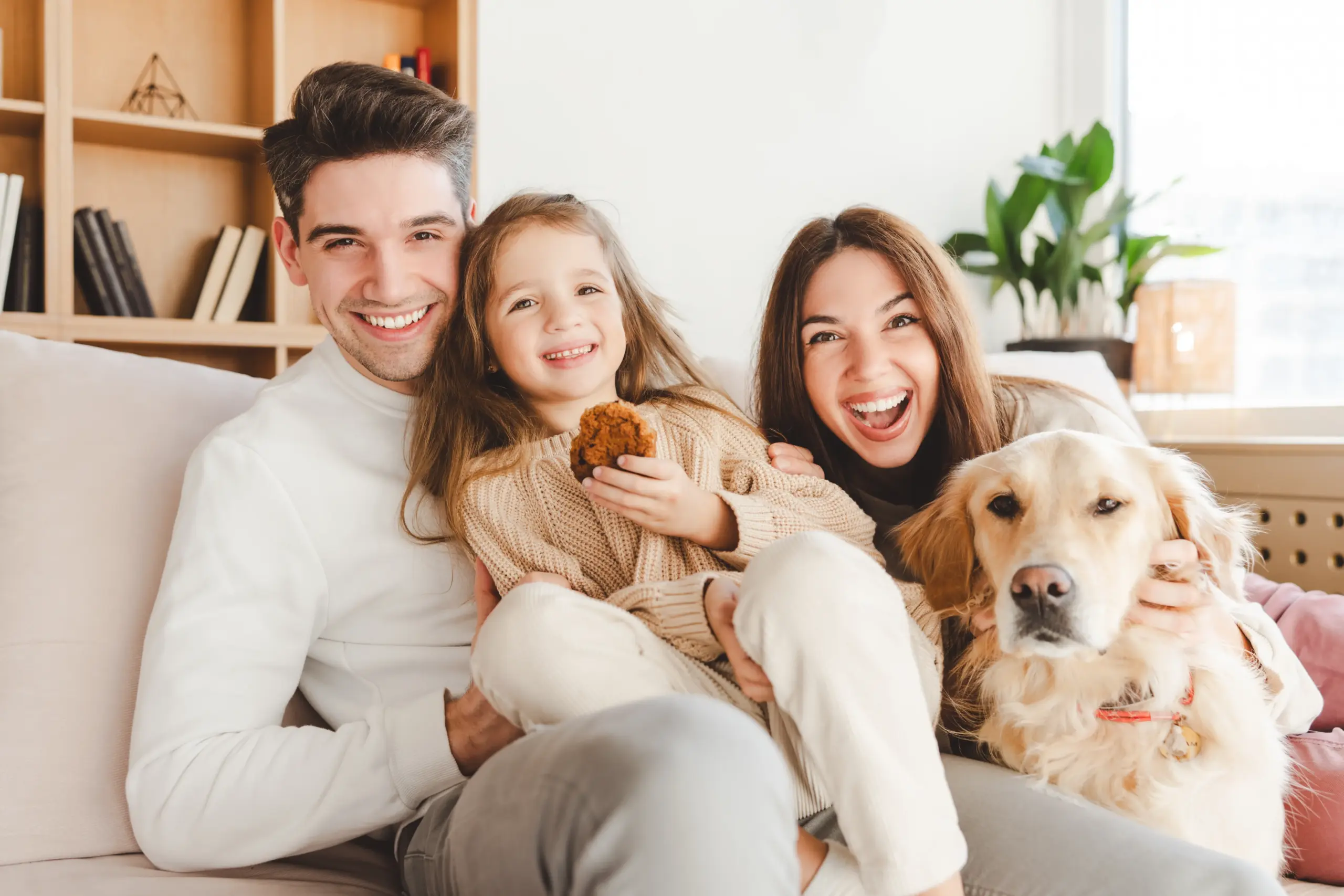 Happy family with child and dog smiling together in Center TX