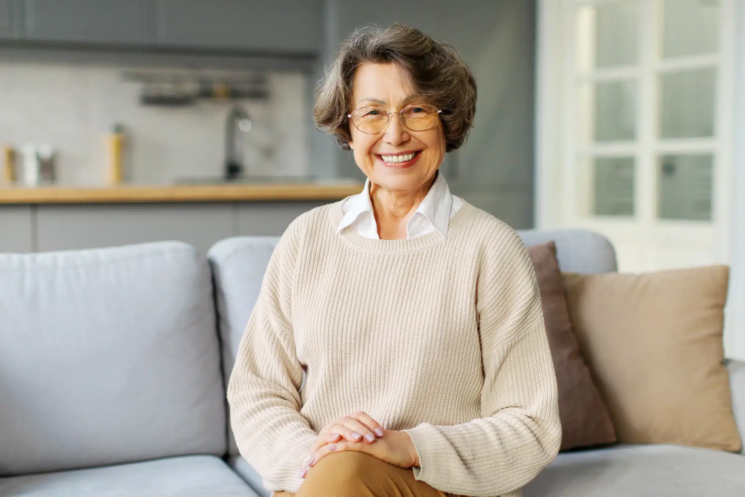 woman smiling with healthy teeth after dentures in Center TX